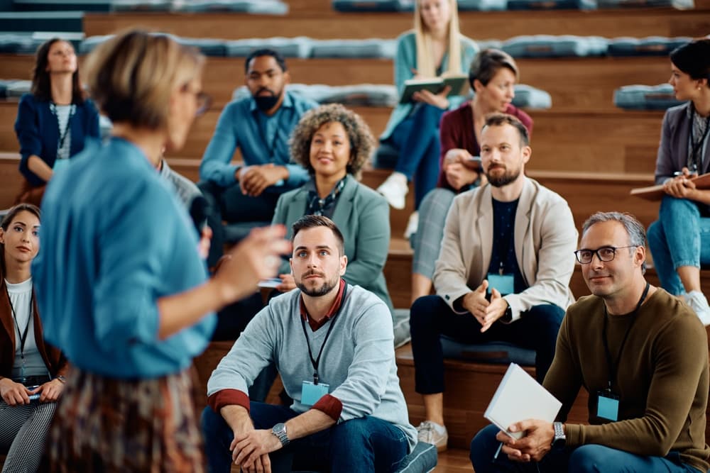 Multiracial,Group,Of,Business,People,Listening,To,A,Speaker,During