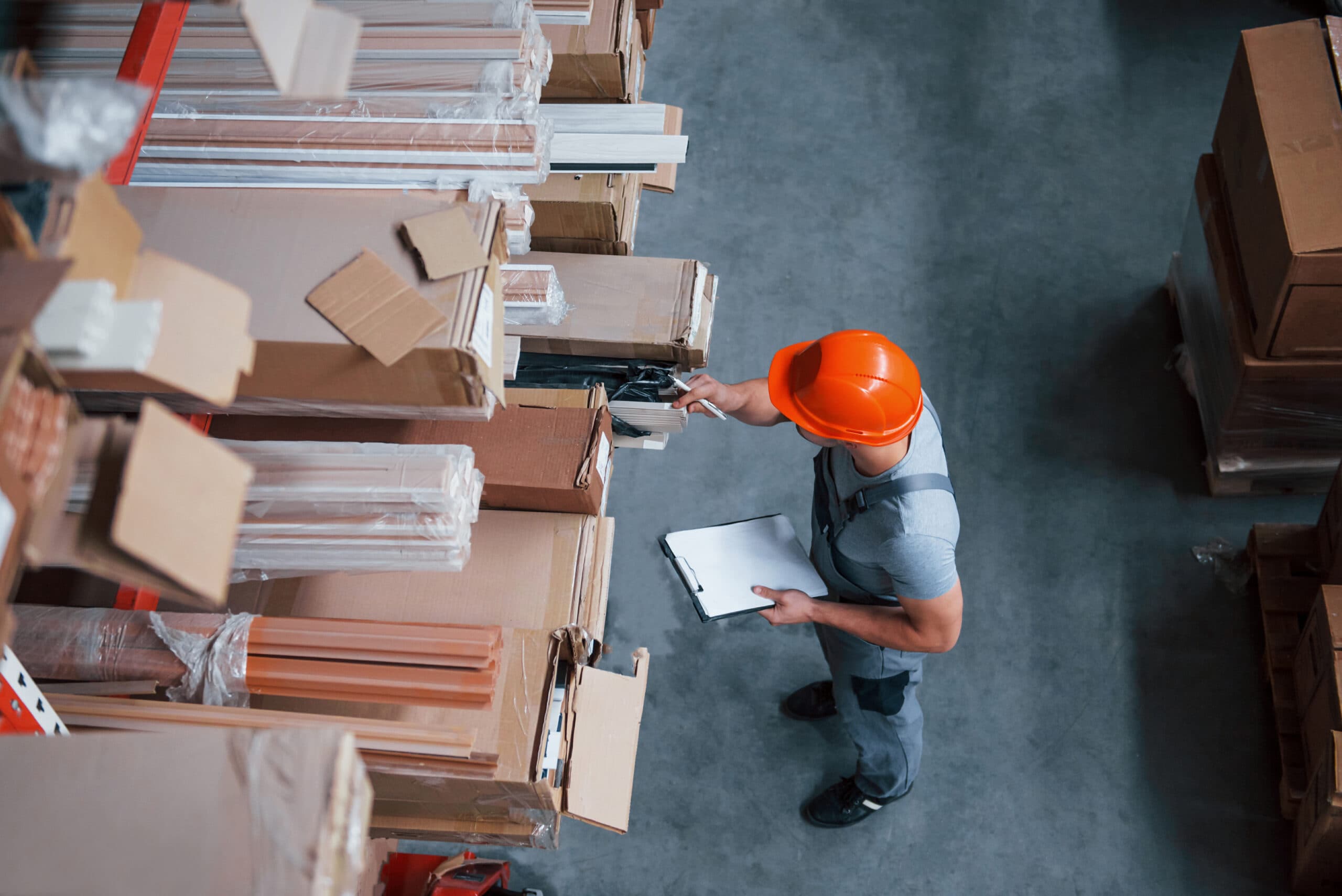 Top,View,Of,Male,Worker,In,Warehouse,With,Notepad,In