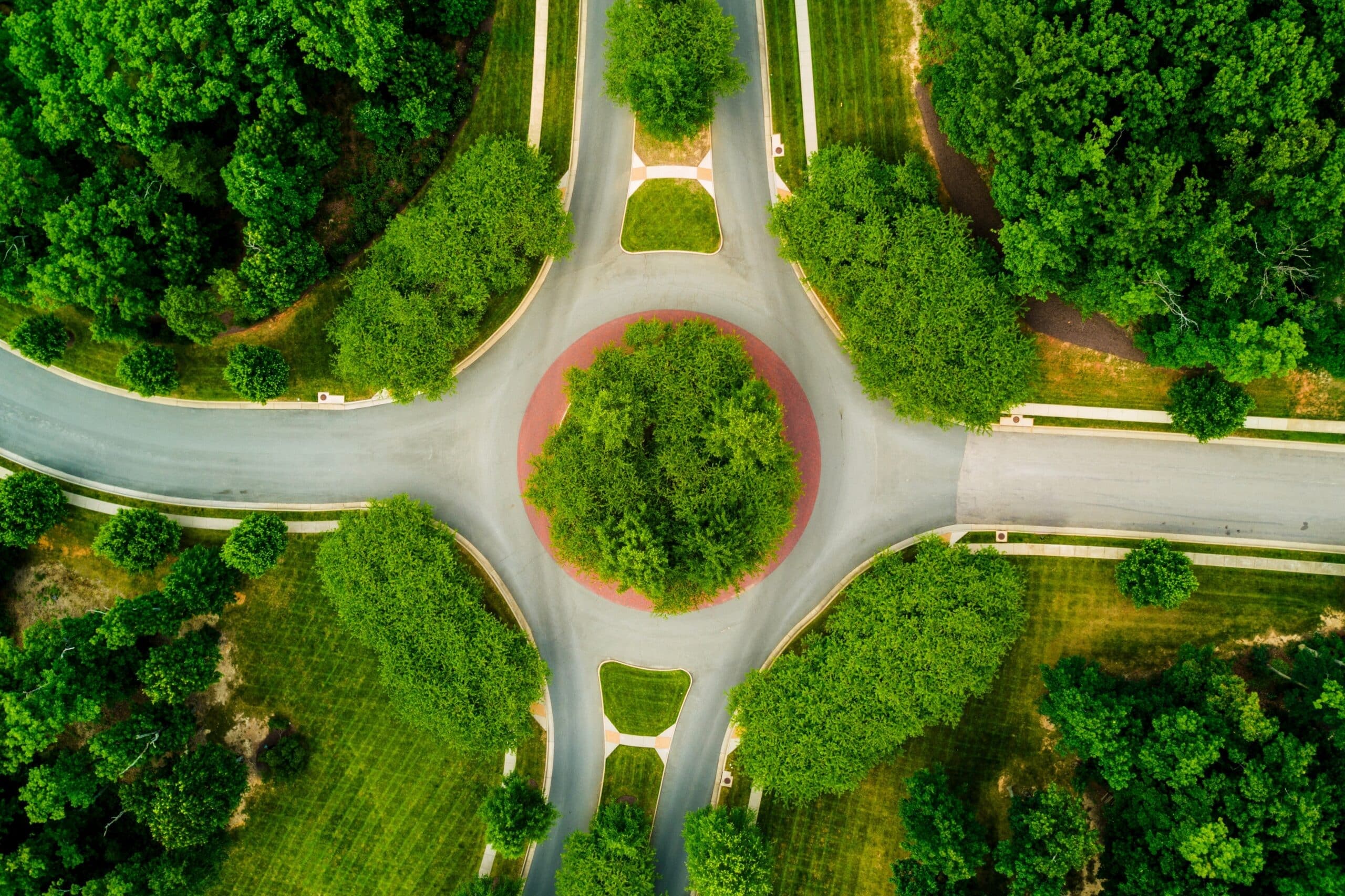 Aerial,View,Of,A,Roundabout,Surrounded,By,Lush,Green,Trees