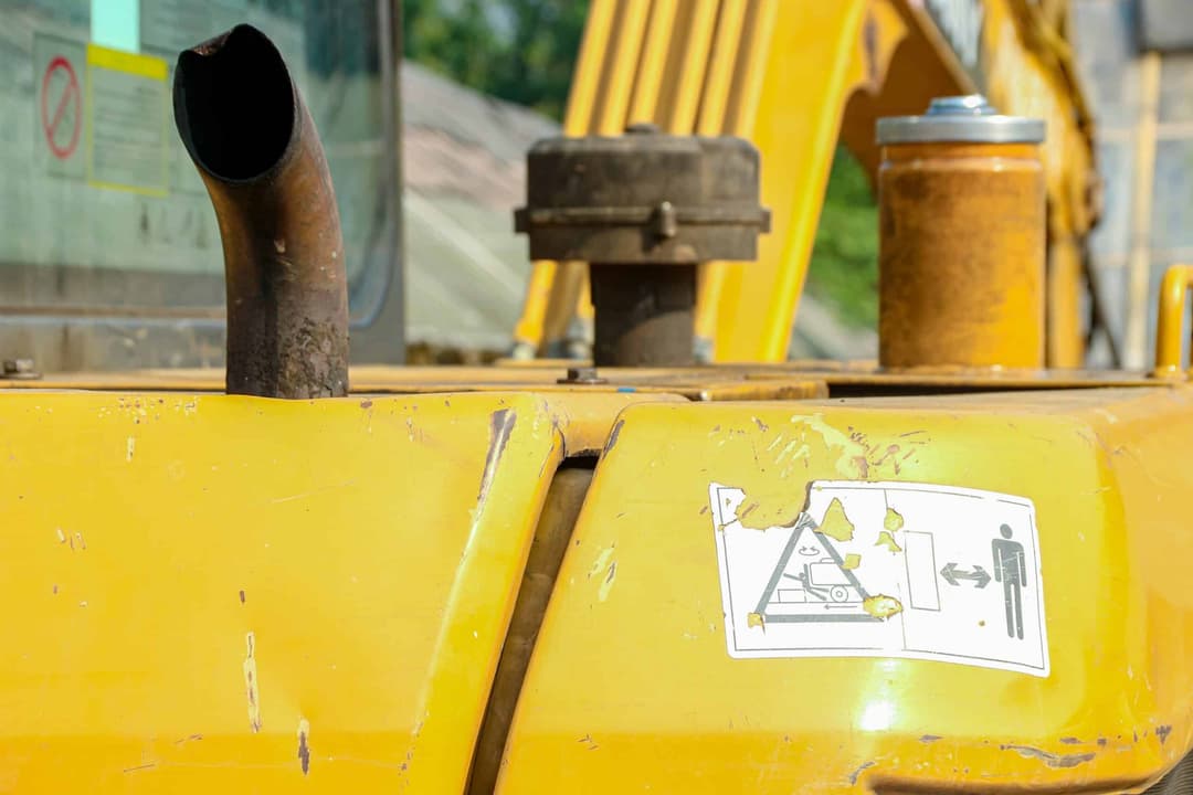 Close-up,Of,Yellow,Construction,Vehicle,With,Rusty,Exhaust,Pipe,And