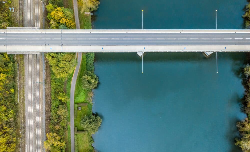 An,Aerial,Shot,Of,A,Bridge,Road,Over,A,River
