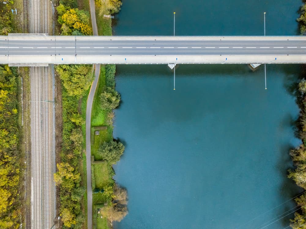 An,Aerial,Shot,Of,A,Bridge,Road,Over,A,River