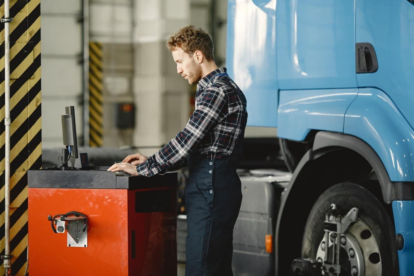 driver-checks-goods-man-uniform-truck-garage_1157-46543