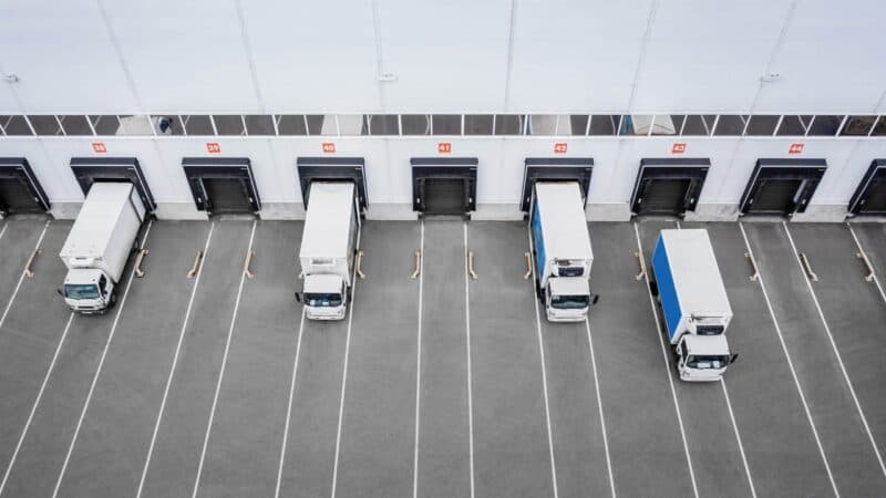 Small,Trucks,Unloading,In,Distribution,Hub.,Aerial,View